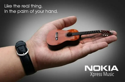 Cây đàn guitar trong lòng bàn tay tượng trưng cho âm nhạc gói gọn trong điện thoại. (Nguồn: Penji)